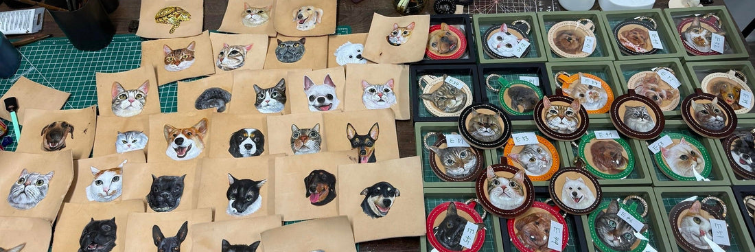 A collection of finished Memopaw custom hand-carved 3D leather pet portraits and keychains in craft paper packaging.