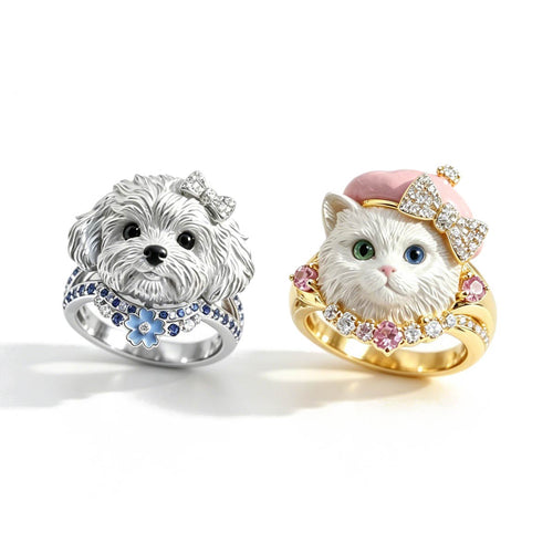 Two rings, one with a dog design and the other with a cat design, on a white background.