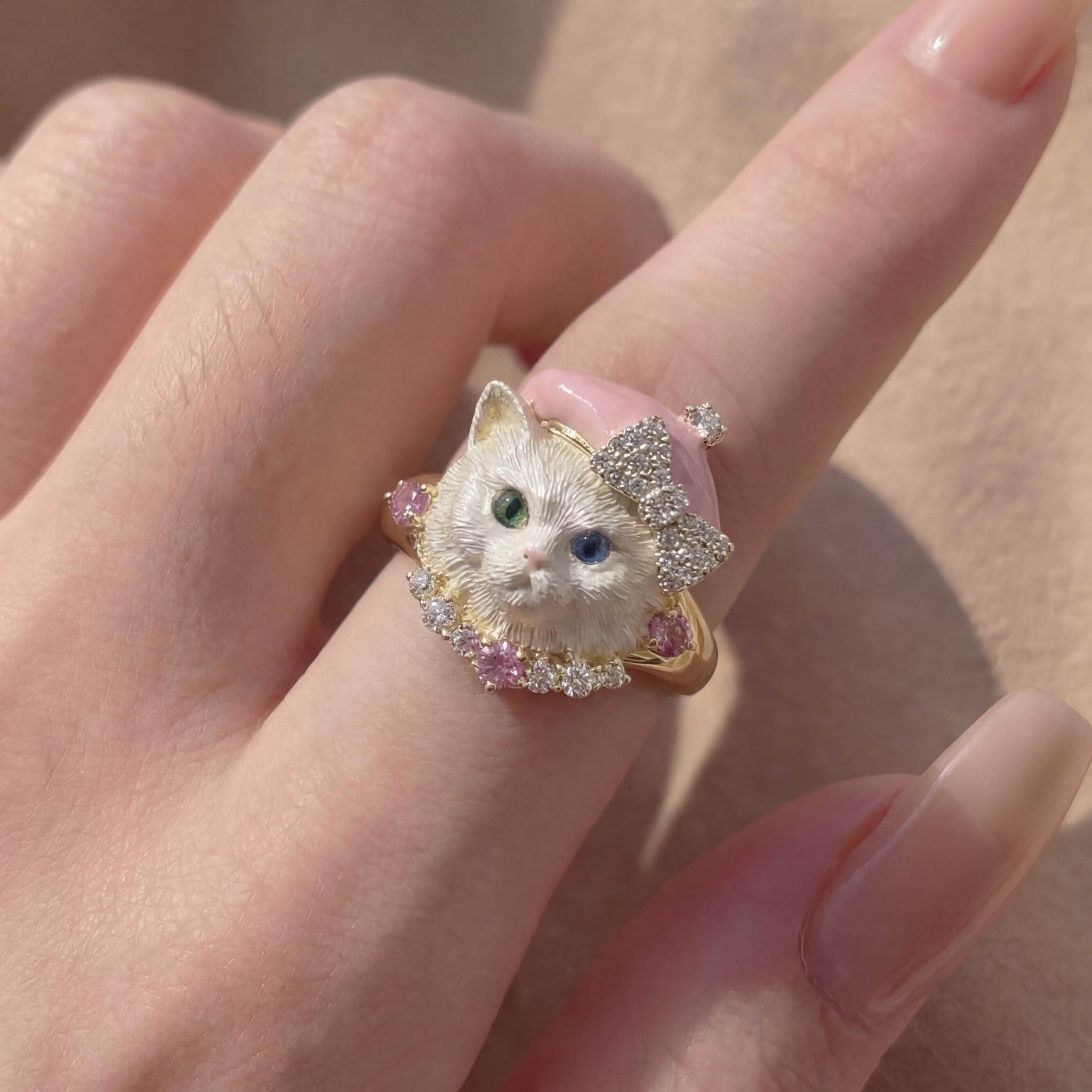 Ring with a cat design on a person's finger