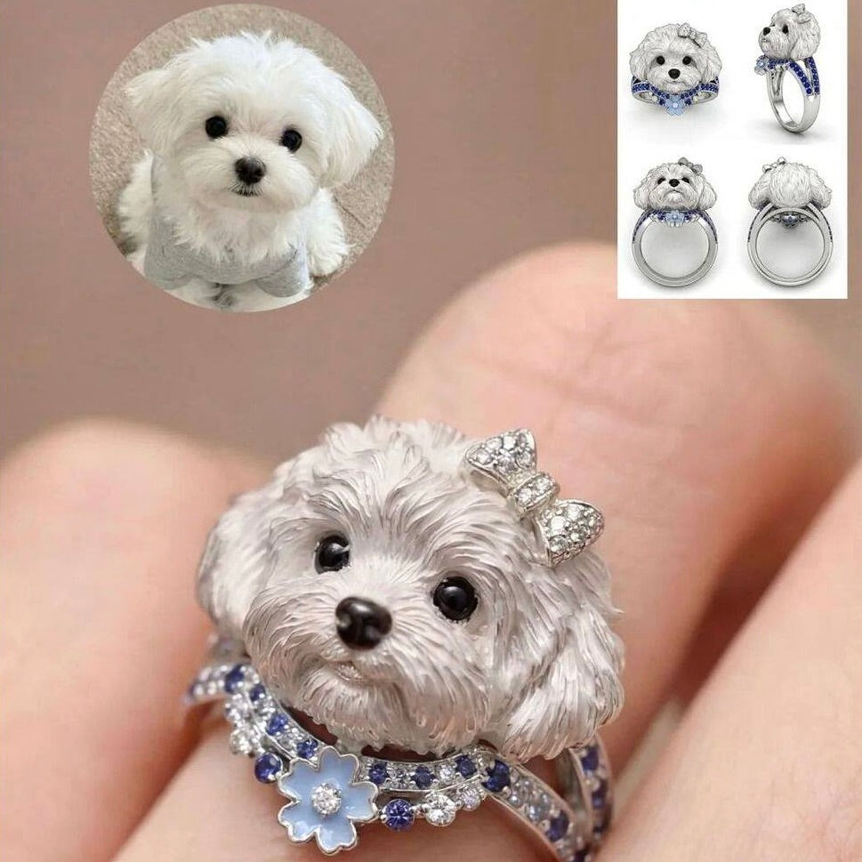 Silver dog-shaped ring with gemstones on a finger, surrounded by close-up insets of the dog and additional rings.