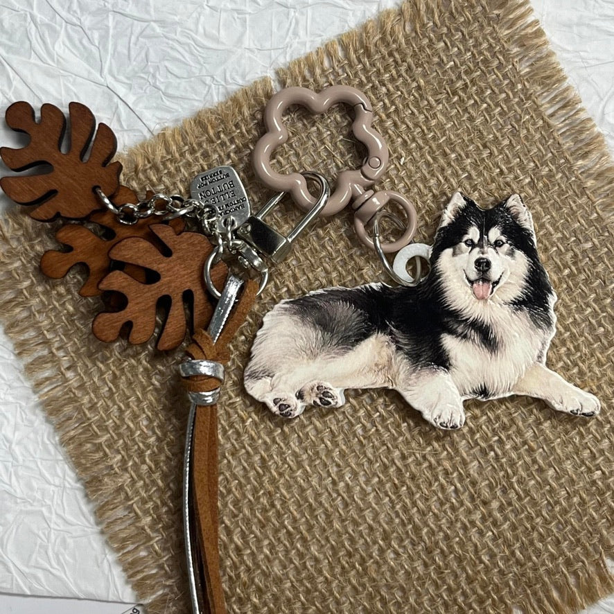 A custom 3D pet relief keychain featuring a detailed hand-painted dog portrait.