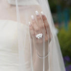 A bride wearing a bespoke 3D dog portrait ring under her wedding veil, custom hand-sculpted as a luxury sentimental keepsake to include her pet in the ceremony.