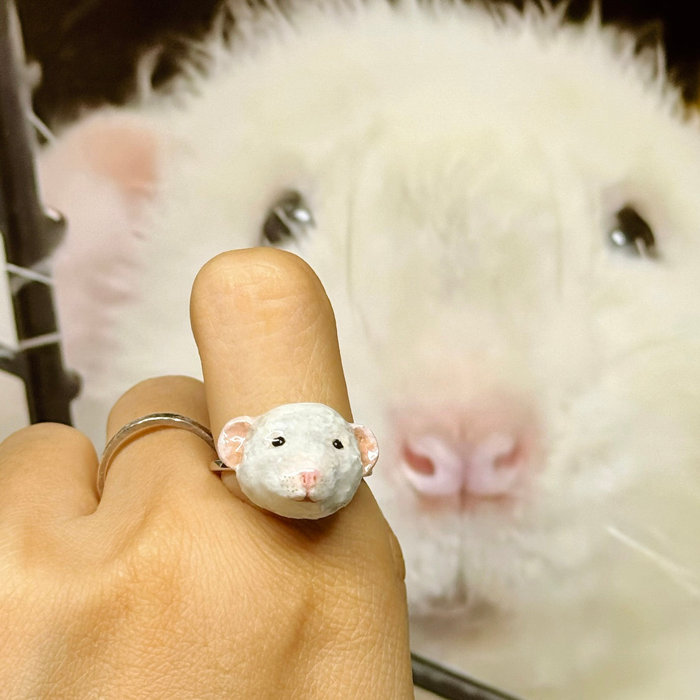 A loyal Tree kangaroo next to a custom hand-sculpted 3D Tree kangaroo portrait ring, a luxury keepsake to include pets in weddings.
