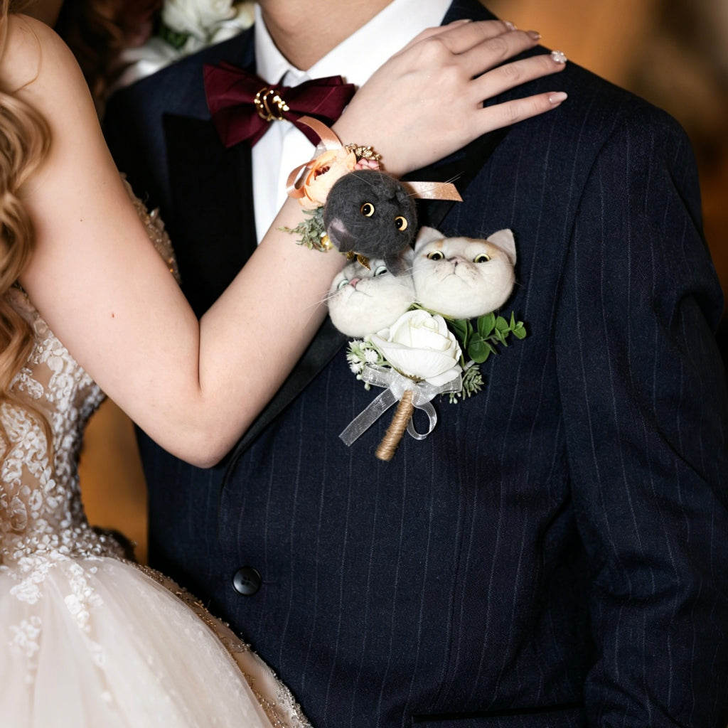 Person wearing a boutonniere with a small stuffed animal and flowers on a dark suit.