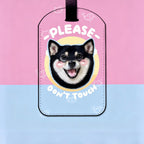 Luggage tag with a dog illustration and text on a pink and blue background