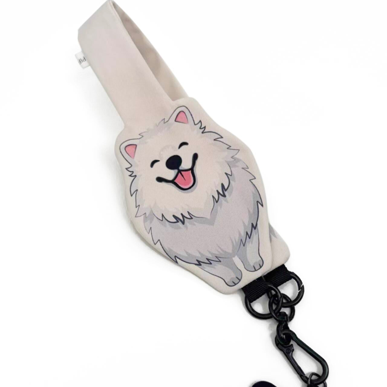 White dog-shaped keychain with a black chain on a white background