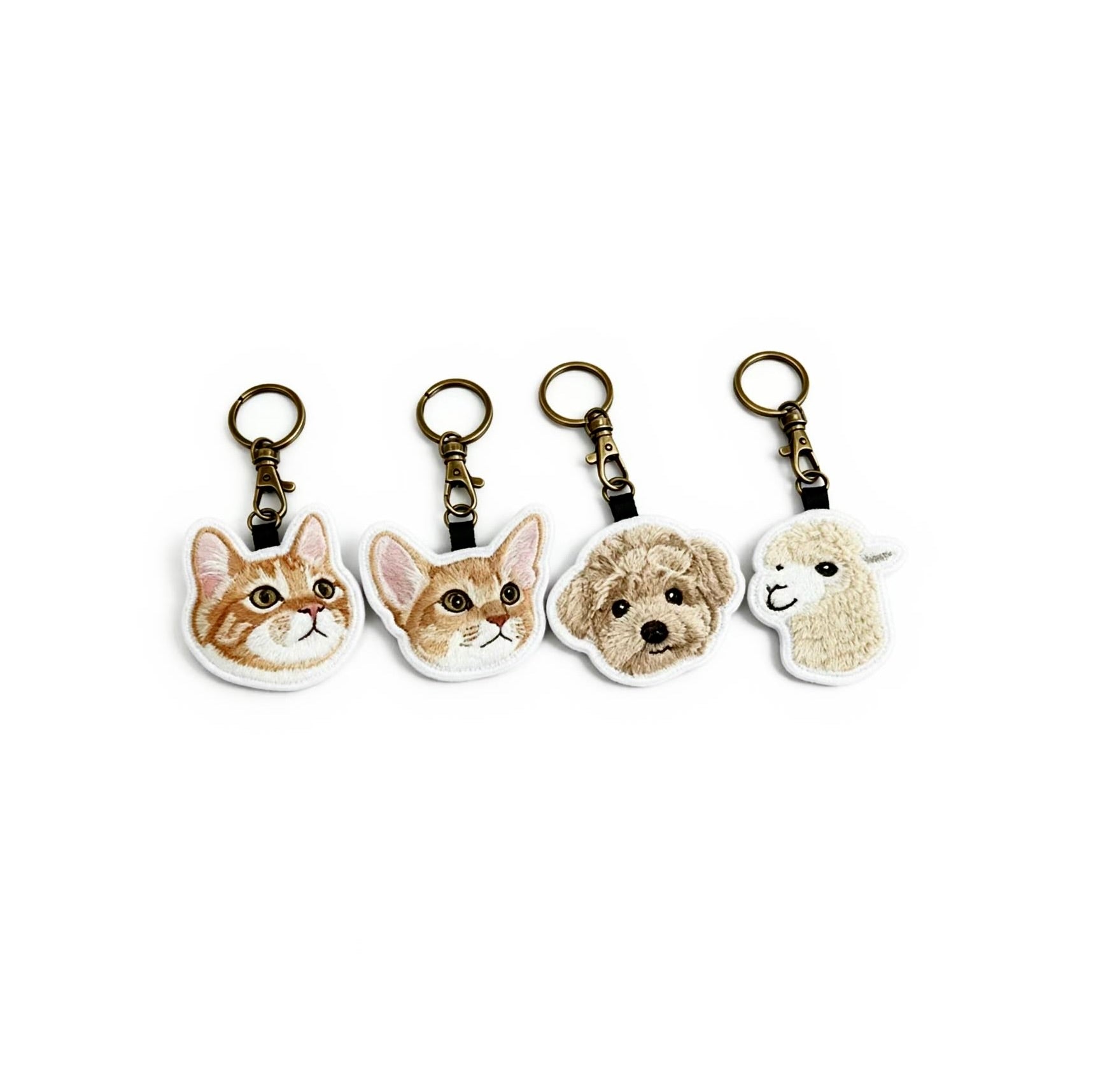 Four animal-themed keychains on a white background