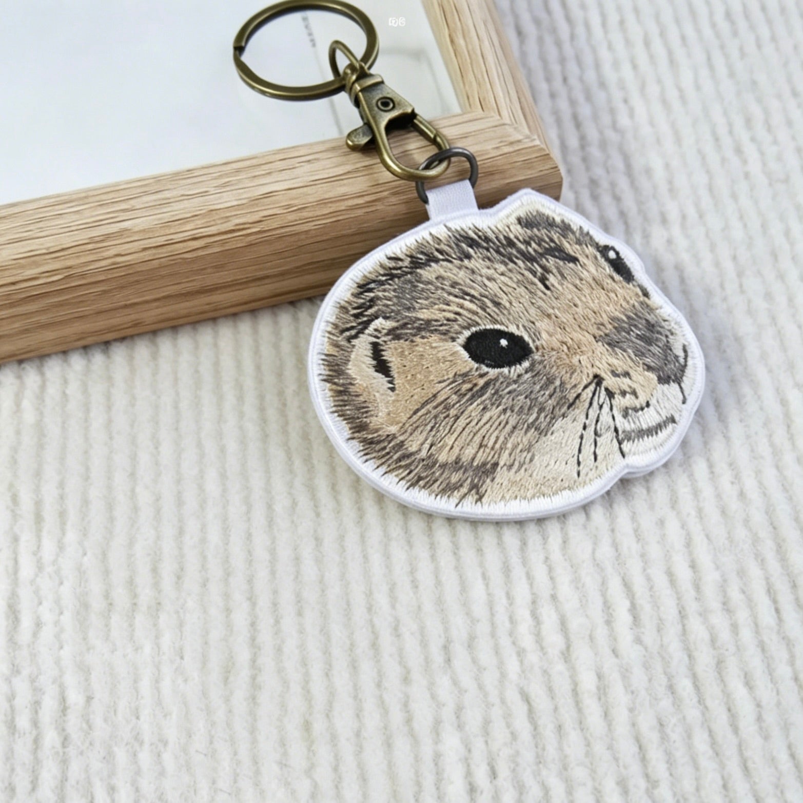 Keychain with a rabbit design on a textured surface