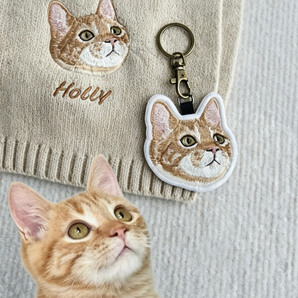 Embroidered cat keychain and patch on a textured fabric background