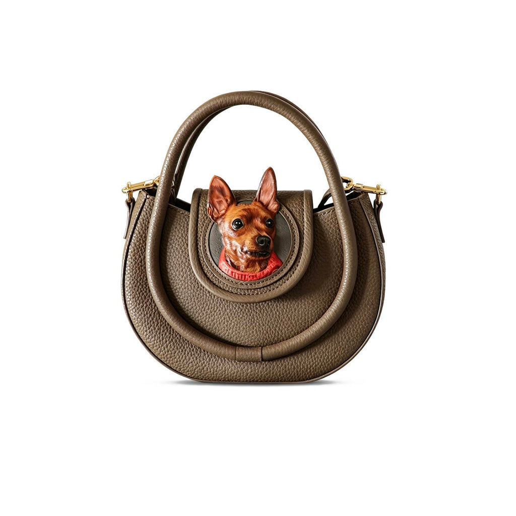 Brown handbag with a dog's face on the front on a white background