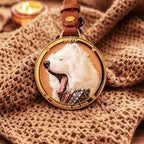 Gold pendant with a white dog design on a textured fabric background