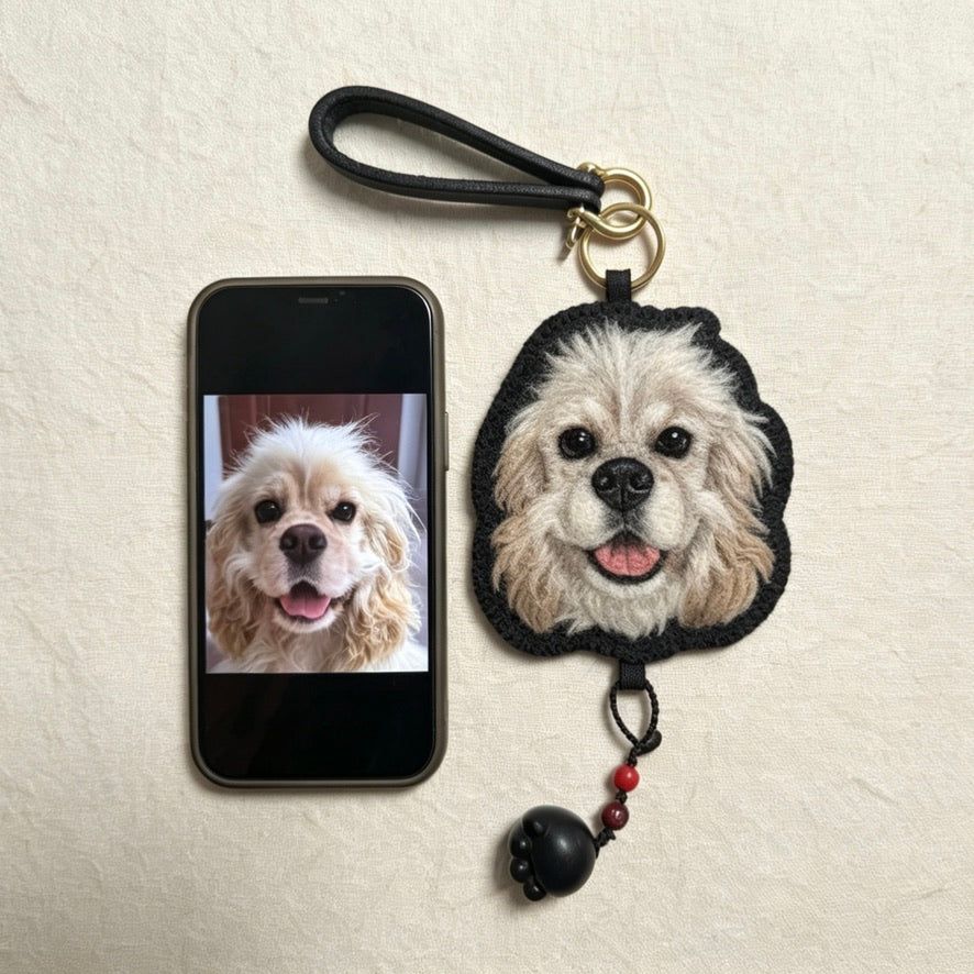 Dog keychain with a phone displaying a dog photo on a beige background