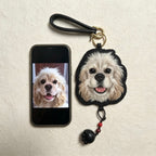 Dog keychain with a phone displaying a dog photo on a beige background