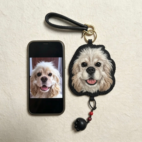 Dog keychain with a phone displaying a dog photo on a beige background