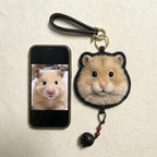 Phone case with a hamster design and matching keychain on a beige background
