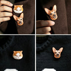 Four views of a brooch shaped like a dog's face on a dark fabric background.