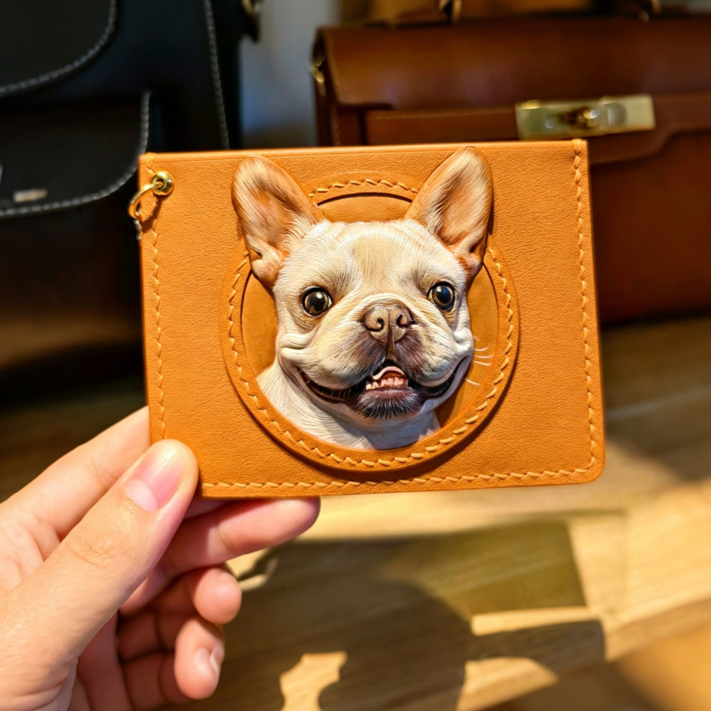Brown leather cardholder with a dog's face design held by a hand.