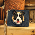 Blue wallet with a dog's face design on a wooden surface