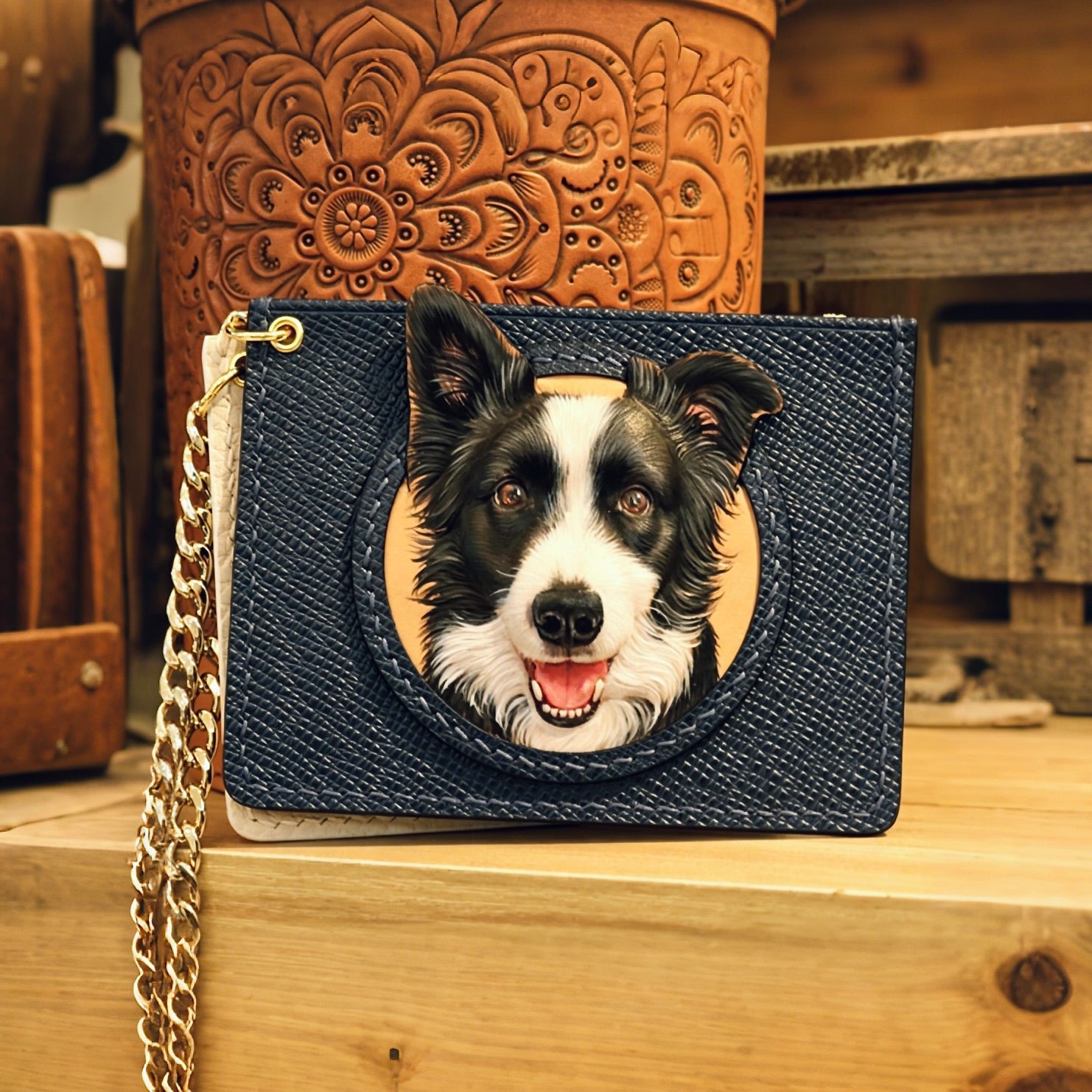Blue wallet with a dog's face design on a wooden surface