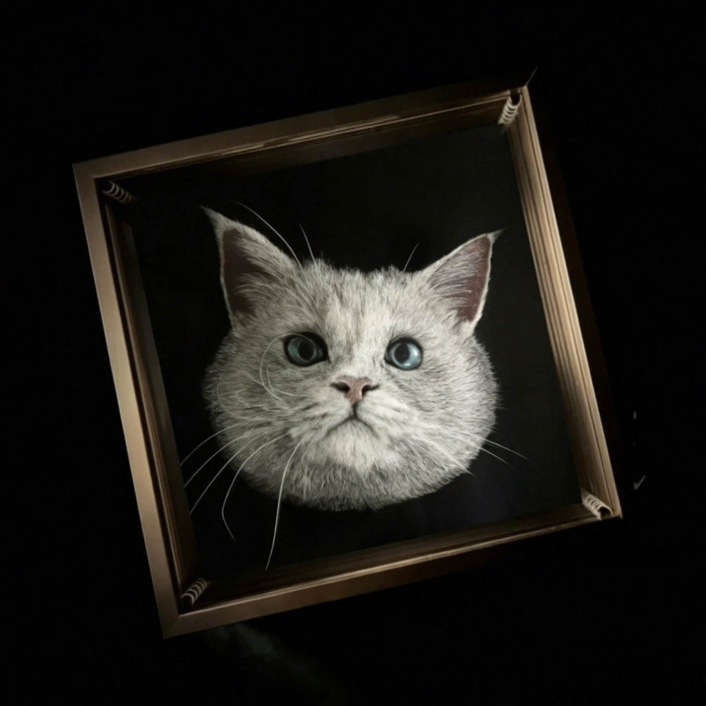 Framed artwork of a cat's face on a black background