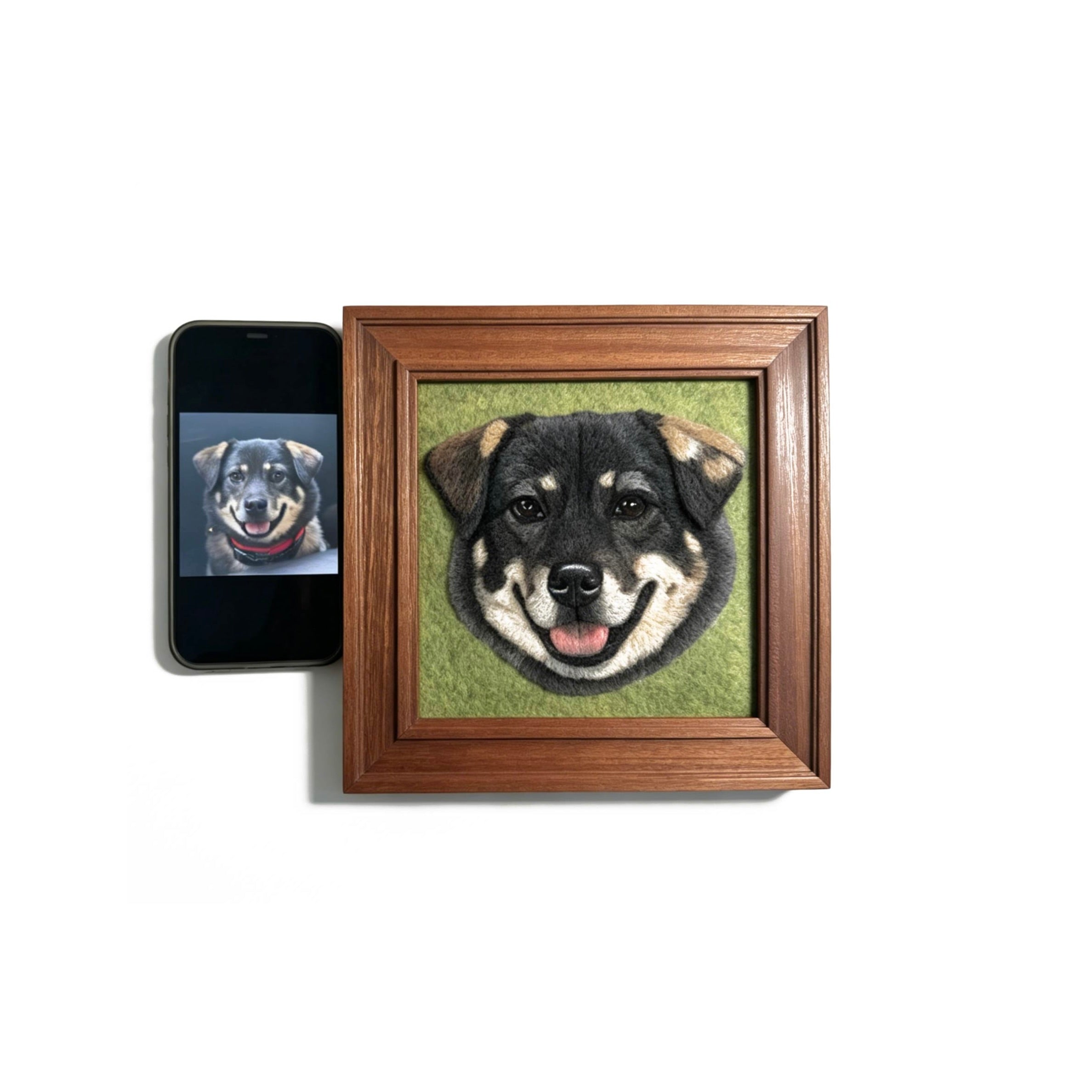 Framed portrait of a dog on a white background with a smartphone displaying a similar image.
