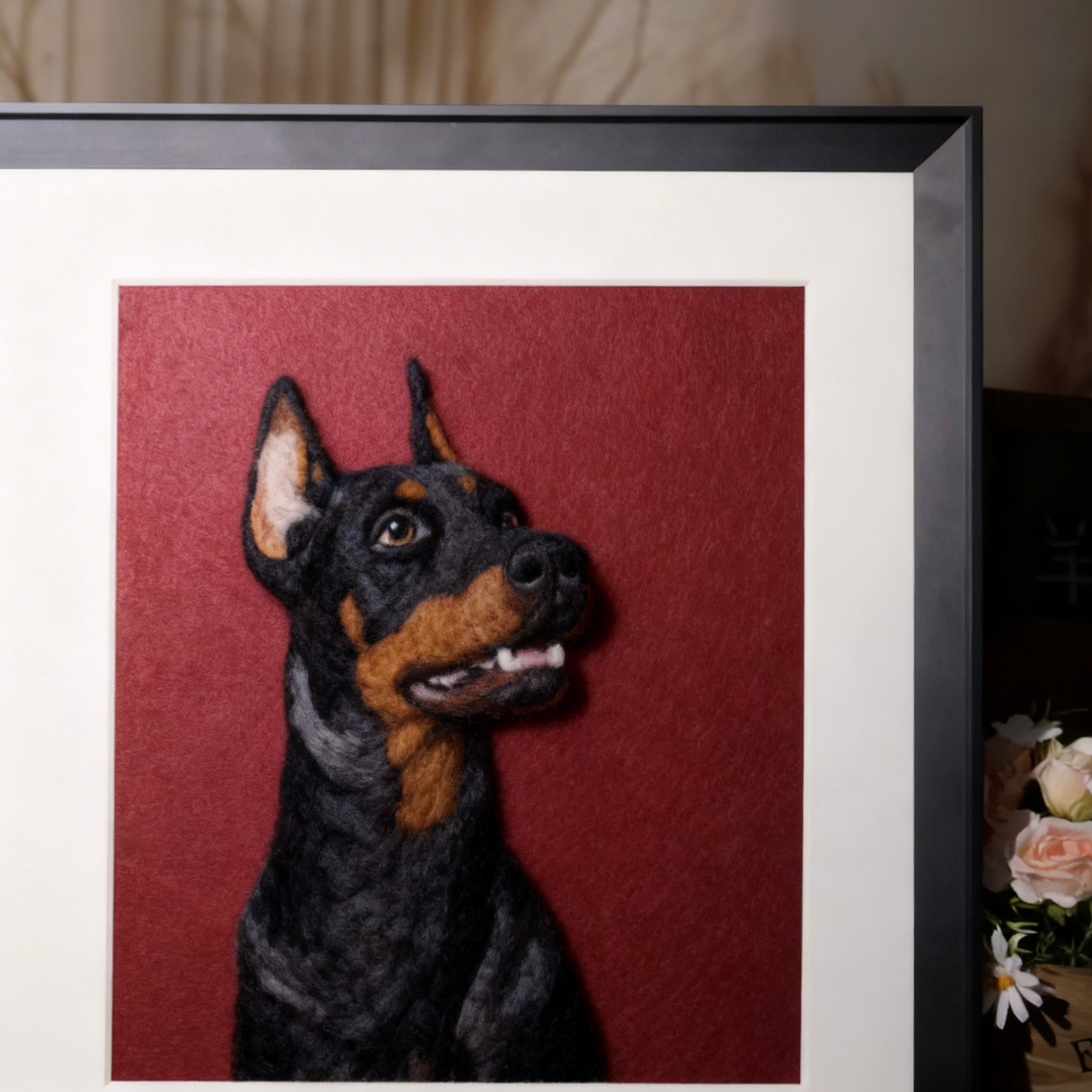 Framed artwork of a dog's head on a red background