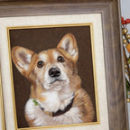Framed portrait of a corgi dog with a brown background