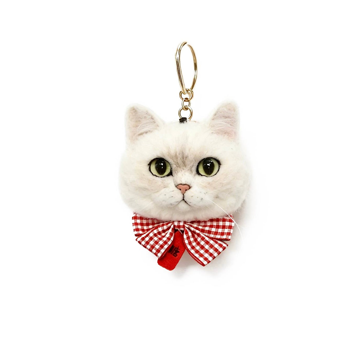White cat-shaped keychain with a red bow on a white background