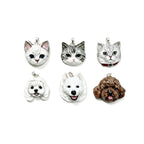 Six unique custom 3D ceramic pet portrait pendants featuring detailed cat and dog faces, hand-sculpted by Memopaw for wearable art.