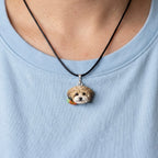 Close-up of a model wearing a custom 3D hand-sculpted dog portrait pendant on a black necklace, showcasing personalized wearable pet jewelry.
