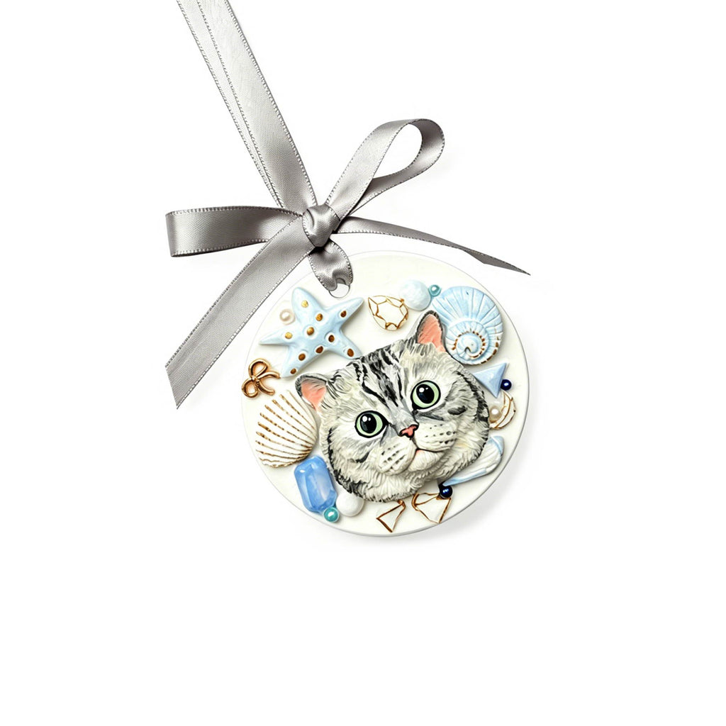 Round ornament with a cat design and silver ribbon on a white background