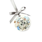 Round ornament with a cat design and silver ribbon on a white background