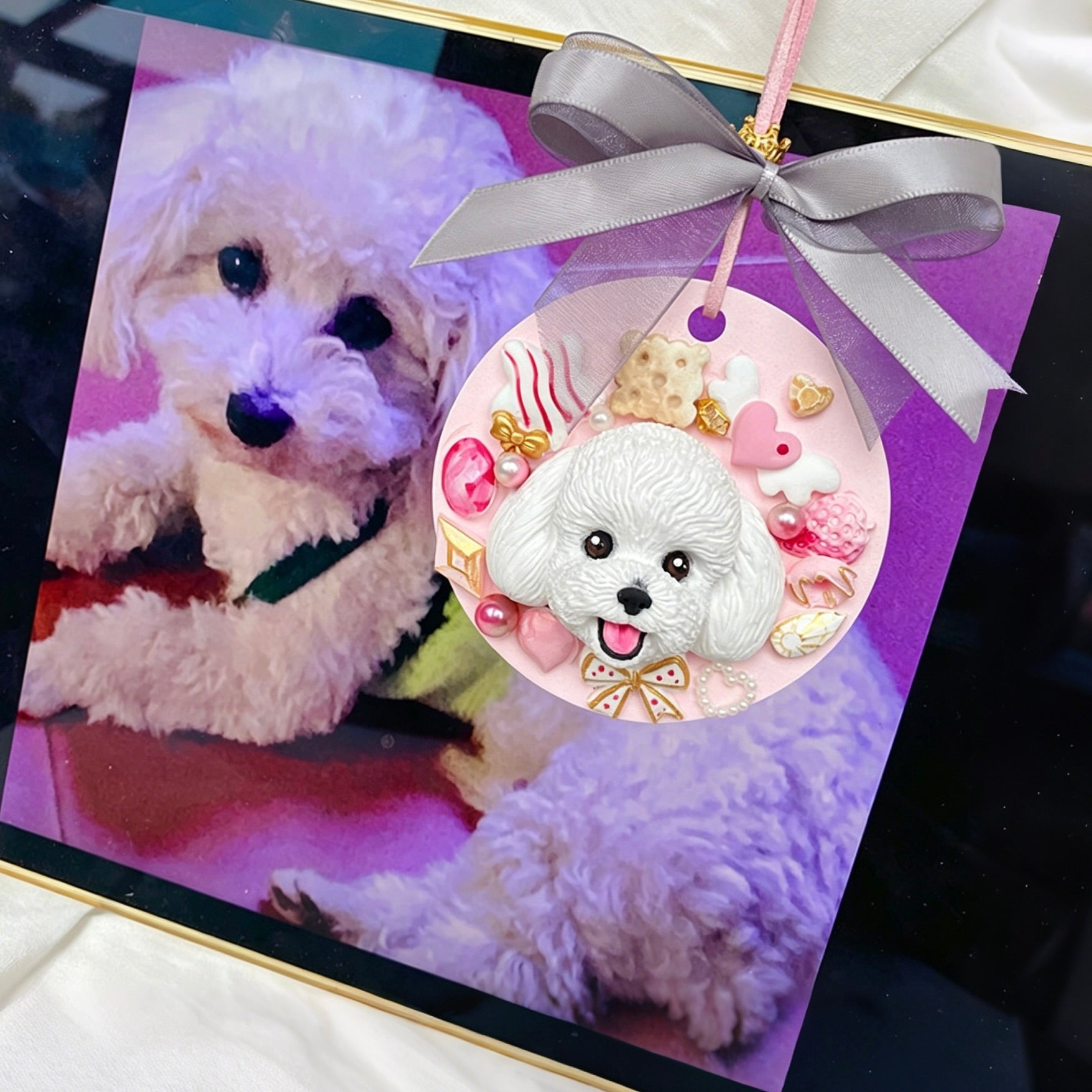 Decorative card with a white dog illustration and a pink ribbon on a dark surface.