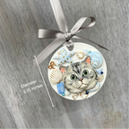 Decorative ornament with a cat illustration and decorative elements on a gray background
