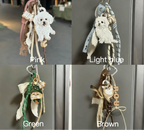 Four keychains with different color options displayed against a neutral background.