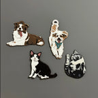 Four dog and cat figurines on a gray background
