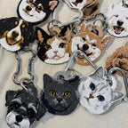 Collection of animal-themed keychains on a textured surface