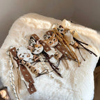 Set of cat-themed keychains on a fluffy white surface