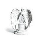 White angel figurine with wings spread holding a candle on a white background