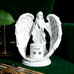 White angel statue with a small container on a dark surface