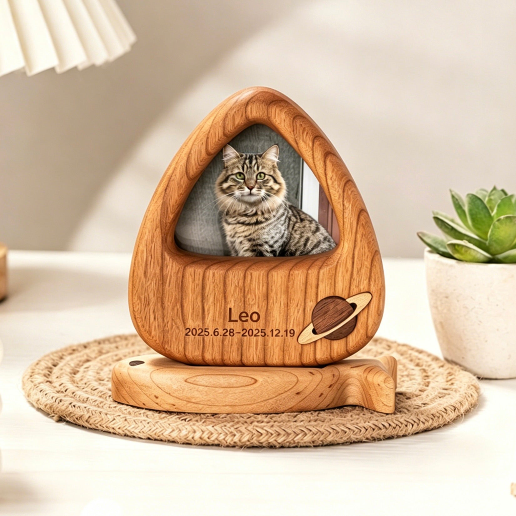Wooden pet memorial with a photo of a cat named Leo on a table.