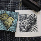 Two cat illustrations on a cutting mat with measurement markings.