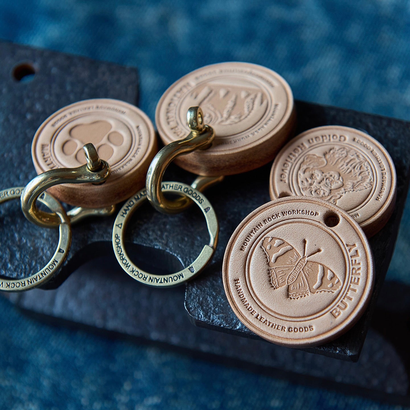 Leather keychains with metal rings on a dark surface