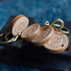 Wooden keychains with metal loops on a dark surface