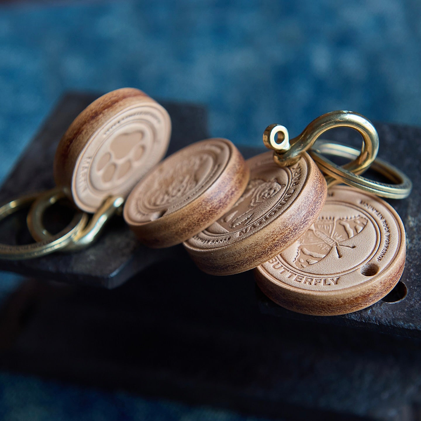 Wooden keychains with metal loops on a dark surface