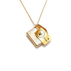 Gold necklace with two pendants on a white background