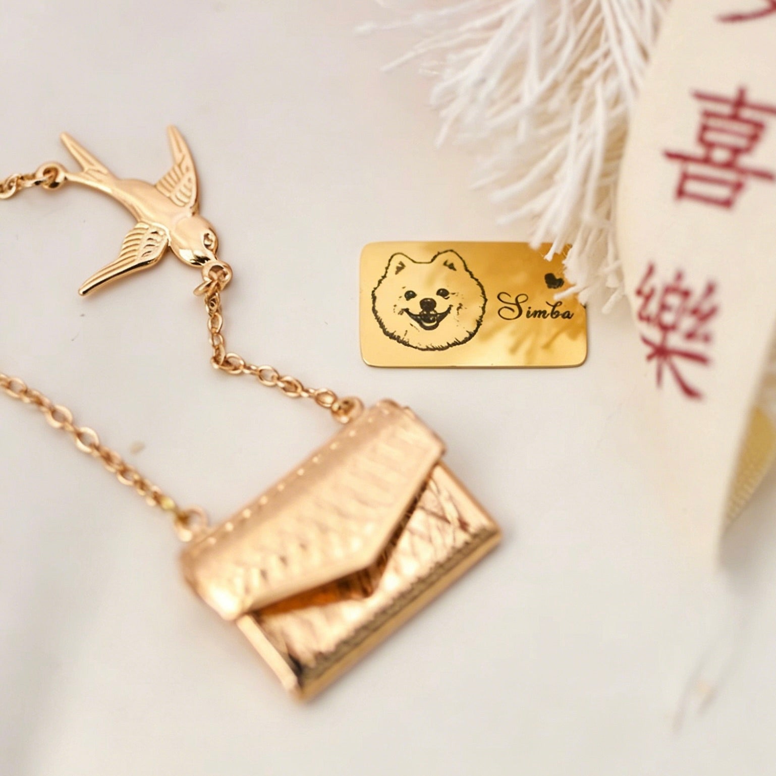 Gold necklace with a dog tag featuring a dog's face and name 'Simba' on a light background.