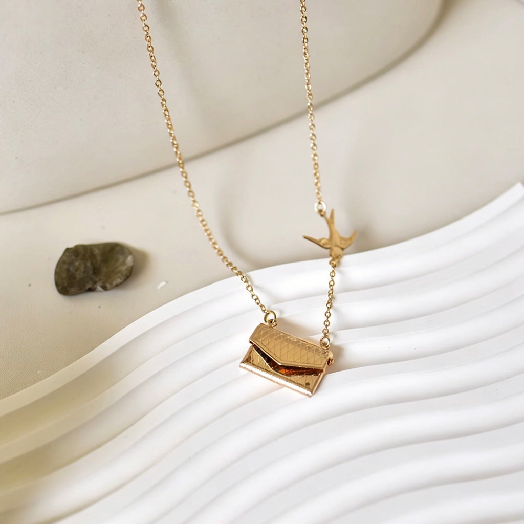Gold necklace with a pendant on a white surface