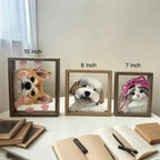 Three framed pet portraits of a dog, cat, and another pet on a table with size labels.