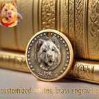 Bronze pendant with engraved dog portrait and date, placed on a gold scroll